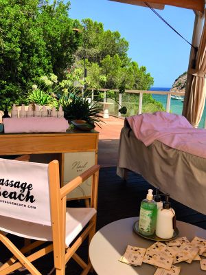 Experience the serene beauty of Ibiza with Massage Beach's poolside treatment set-up, offering breathtaking views of the Mediterranean Sea.